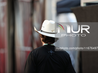 A man wears a COTA-themed cowboy hat in the paddock at Circuit of the Americas in Austin, Texas, on October 17, 2024. (