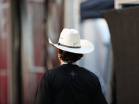 A man wears a COTA-themed cowboy hat in the paddock at Circuit of the Americas in Austin, Texas, on October 17, 2024. (