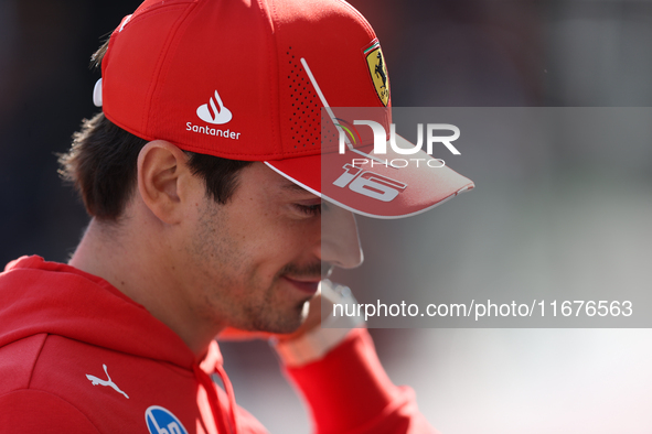 Charles Leclerc walks through the paddock. 