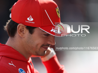 Charles Leclerc walks through the paddock. (