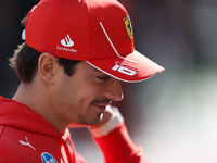 Charles Leclerc walks through the paddock. (