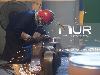 A worker welds machinery parts for export at a machinery manufacturing workshop in Hangzhou, Zhejiang province, China, on October 18, 2024....