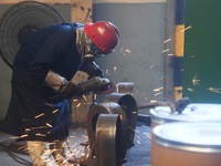 A worker welds machinery parts for export at a machinery manufacturing workshop in Hangzhou, Zhejiang province, China, on October 18, 2024....