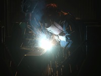 A worker welds machinery parts for export at a machinery manufacturing workshop in Hangzhou, Zhejiang province, China, on October 18, 2024....