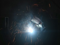 A worker welds machinery parts for export at a machinery manufacturing workshop in Hangzhou, Zhejiang province, China, on October 18, 2024....