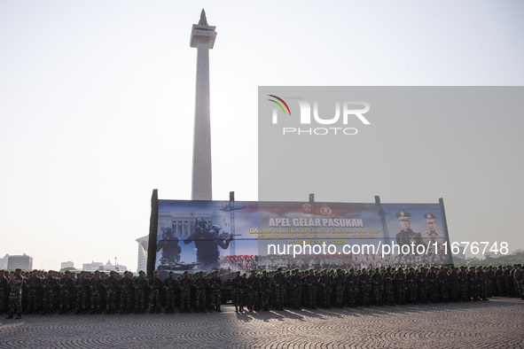 Thousands of armed forces and police personnel take part in a troop roll call at the National Monument in Jakarta, Indonesia, on October 18,...