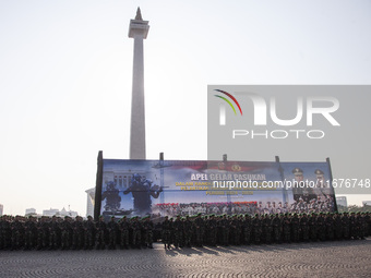 Thousands of armed forces and police personnel take part in a troop roll call at the National Monument in Jakarta, Indonesia, on October 18,...