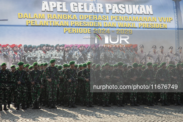 Thousands of armed forces and police personnel take part in a troop roll call at the National Monument in Jakarta, Indonesia, on October 18,...