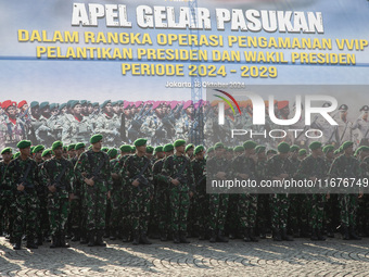 Thousands of armed forces and police personnel take part in a troop roll call at the National Monument in Jakarta, Indonesia, on October 18,...