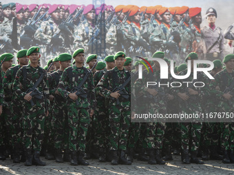 Thousands of armed forces and police personnel take part in a troop roll call at the National Monument in Jakarta, Indonesia, on October 18,...