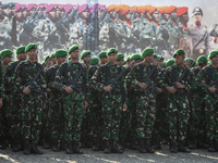 Thousands of armed forces and police personnel take part in a troop roll call at the National Monument in Jakarta, Indonesia, on October 18,...