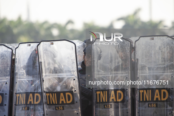 Thousands of armed forces and police personnel take part in a troop roll call at the National Monument in Jakarta, Indonesia, on October 18,...