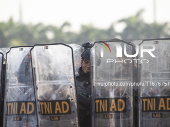 Thousands of armed forces and police personnel take part in a troop roll call at the National Monument in Jakarta, Indonesia, on October 18,...