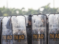 Thousands of armed forces and police personnel take part in a troop roll call at the National Monument in Jakarta, Indonesia, on October 18,...