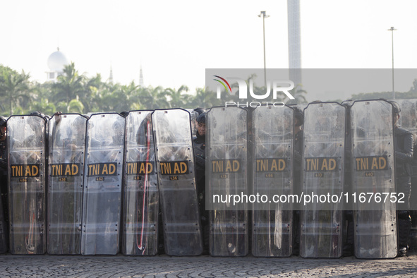 Thousands of armed forces and police personnel take part in a troop roll call at the National Monument in Jakarta, Indonesia, on October 18,...