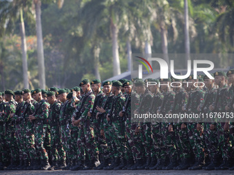 Thousands of armed forces and police personnel take part in a troop roll call at the National Monument in Jakarta, Indonesia, on October 18,...