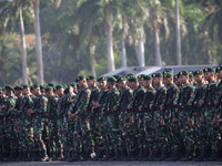 Thousands of armed forces and police personnel take part in a troop roll call at the National Monument in Jakarta, Indonesia, on October 18,...