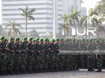 Thousands of armed forces and police personnel take part in a troop roll call at the National Monument in Jakarta, Indonesia, on October 18,...