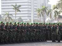 Thousands of armed forces and police personnel take part in a troop roll call at the National Monument in Jakarta, Indonesia, on October 18,...