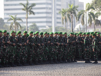 Thousands of armed forces and police personnel take part in a troop roll call at the National Monument in Jakarta, Indonesia, on October 18,...