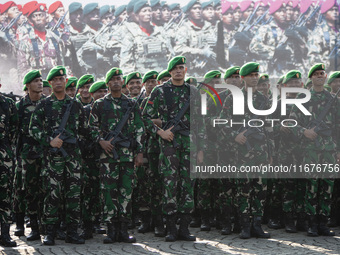 Thousands of armed forces and police personnel take part in a troop roll call at the National Monument in Jakarta, Indonesia, on October 18,...