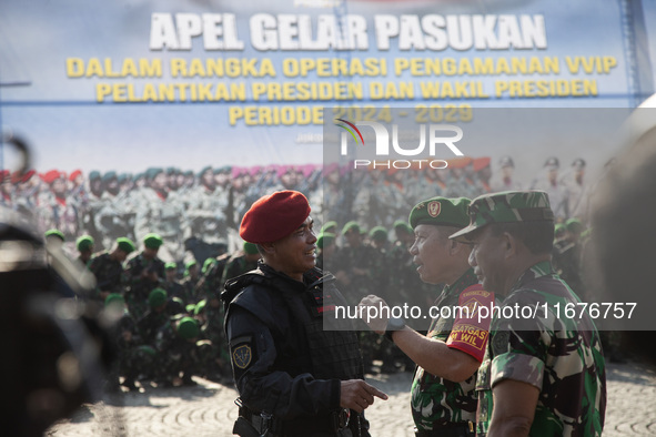 Thousands of armed forces and police personnel take part in a troop roll call at the National Monument in Jakarta, Indonesia, on October 18,...