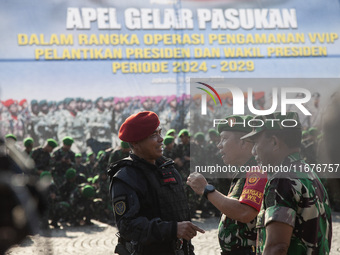 Thousands of armed forces and police personnel take part in a troop roll call at the National Monument in Jakarta, Indonesia, on October 18,...