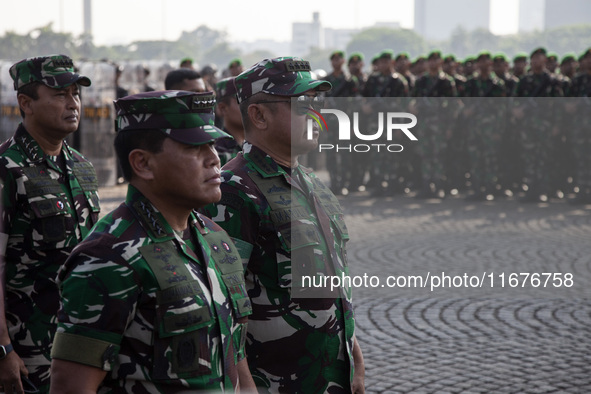 Thousands of armed forces and police personnel take part in a troop roll call at the National Monument in Jakarta, Indonesia, on October 18,...