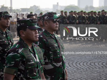 Thousands of armed forces and police personnel take part in a troop roll call at the National Monument in Jakarta, Indonesia, on October 18,...