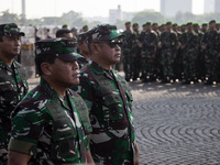 Thousands of armed forces and police personnel take part in a troop roll call at the National Monument in Jakarta, Indonesia, on October 18,...