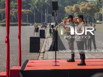 Indonesian Chief of Armed Forces, General Agus Subianto, and Police Chief, General Listyo Sigit Prabowo, lead the roll call of troops at the...