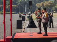 Indonesian Chief of Armed Forces, General Agus Subianto, and Police Chief, General Listyo Sigit Prabowo, lead the roll call of troops at the...