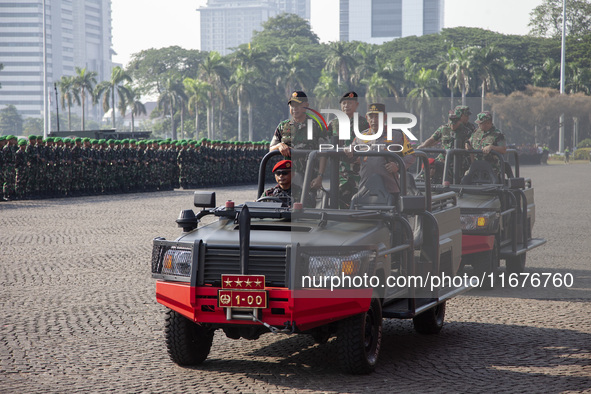 TNI Commander General Agus Subianto (left) and National Police Chief General Listyo Sigit Prabowo (right) inspect troops while leading a joi...