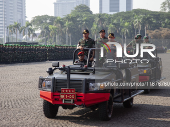 TNI Commander General Agus Subianto (left) and National Police Chief General Listyo Sigit Prabowo (right) inspect troops while leading a joi...