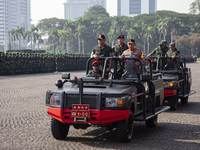 TNI Commander General Agus Subianto (left) and National Police Chief General Listyo Sigit Prabowo (right) inspect troops while leading a joi...