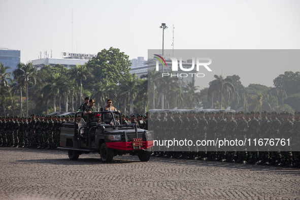 TNI Commander General Agus Subianto (right) and National Police Chief General Listyo Sigit Prabowo (left) inspect troops while leading a joi...