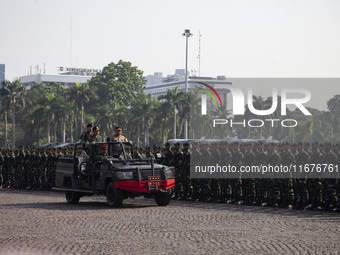 TNI Commander General Agus Subianto (right) and National Police Chief General Listyo Sigit Prabowo (left) inspect troops while leading a joi...