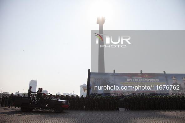 Thousands of armed forces and police personnel take part in a troop roll call at the National Monument in Jakarta, Indonesia, on October 18,...