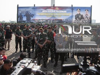 TNI Commander General Agus Subianto (left) and National Police Chief General Listyo Sigit Prabowo (right) speak during the press conference...