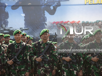 Thousands of armed forces and police personnel take part in a troop roll call at the National Monument in Jakarta, Indonesia, on October 18,...