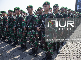 Thousands of armed forces and police personnel take part in a troop roll call at the National Monument in Jakarta, Indonesia, on October 18,...