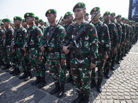 Thousands of armed forces and police personnel take part in a troop roll call at the National Monument in Jakarta, Indonesia, on October 18,...