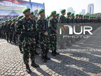 Thousands of armed forces and police personnel take part in a troop roll call at the National Monument in Jakarta, Indonesia, on October 18,...