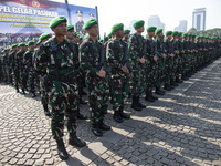 Thousands of armed forces and police personnel take part in a troop roll call at the National Monument in Jakarta, Indonesia, on October 18,...