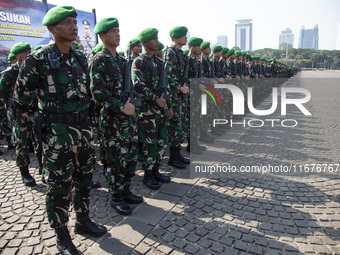 Thousands of armed forces and police personnel take part in a troop roll call at the National Monument in Jakarta, Indonesia, on October 18,...