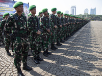 Thousands of armed forces and police personnel take part in a troop roll call at the National Monument in Jakarta, Indonesia, on October 18,...