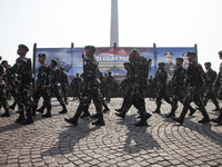 Thousands of armed forces and police personnel take part in a troop roll call at the National Monument in Jakarta, Indonesia, on October 18,...