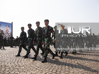 Thousands of armed forces and police personnel take part in a troop roll call at the National Monument in Jakarta, Indonesia, on October 18,...