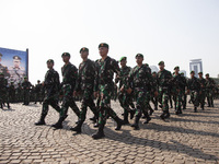 Thousands of armed forces and police personnel take part in a troop roll call at the National Monument in Jakarta, Indonesia, on October 18,...