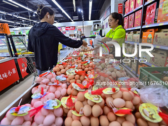 Consumers shop at a supermarket in Qingzhou, China, on October 13, 2024. On October 13, 2024, data released by the National Bureau of Statis...